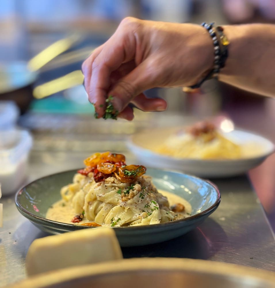 Tagliatelle being plated